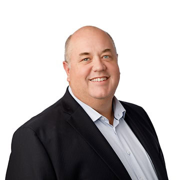Male business professional smiling in formal attire.