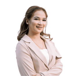 Professional woman smiling confidently with arms crossed.