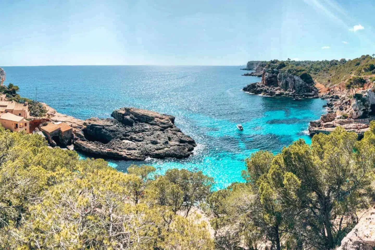 A small boat off the coast in a secluded cove
