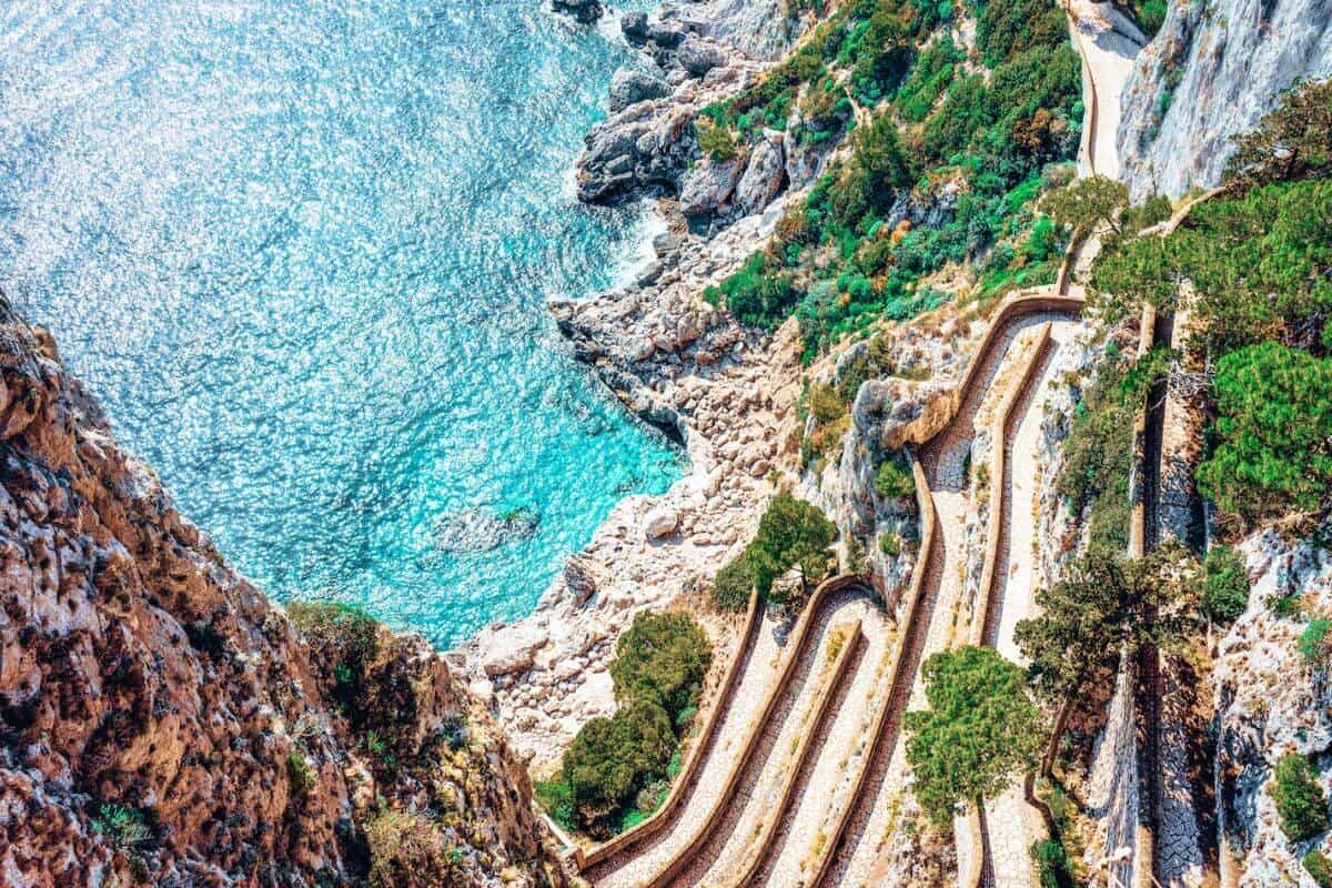 An aerial view of rugged coastal scenery and turquoise sea in Capri