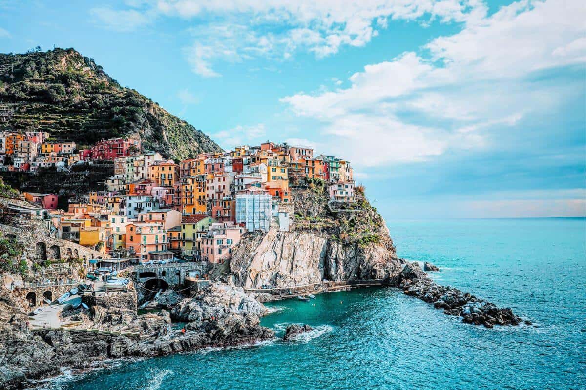 A small town with colourful buildings built into a coastal cliff