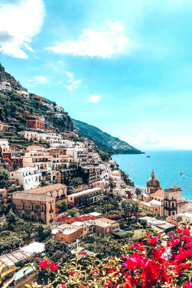 Picturesque pastel buildings built into a cliffside by the sea