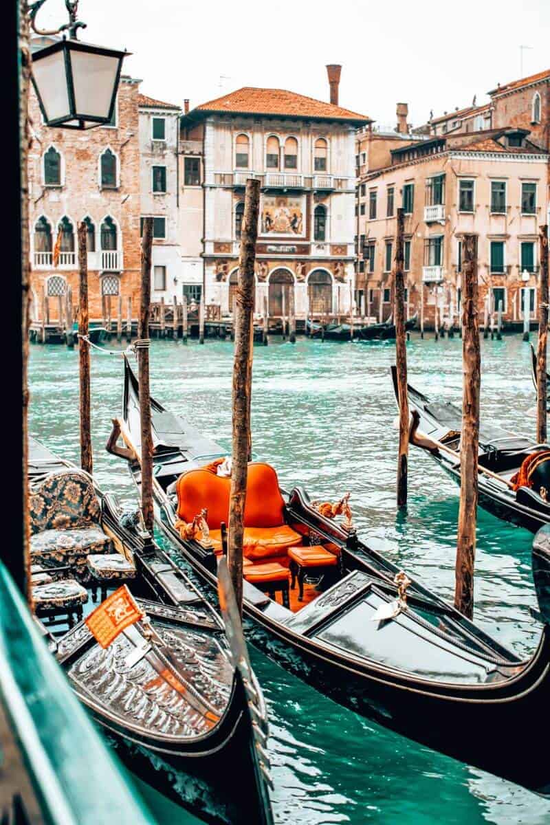 Several gondolas docked on a canal in Venice