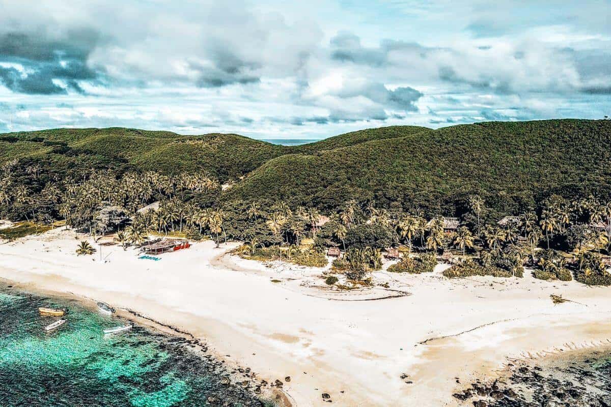 A drone view looking down on an empty tropical beach
