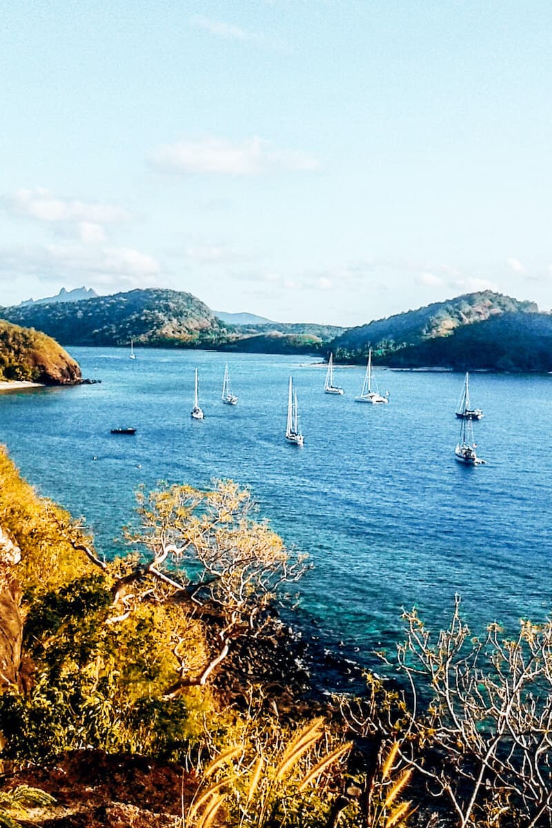 A view from a lookout on Drawaqa island in Fiji towards other islands and small boats in the sea