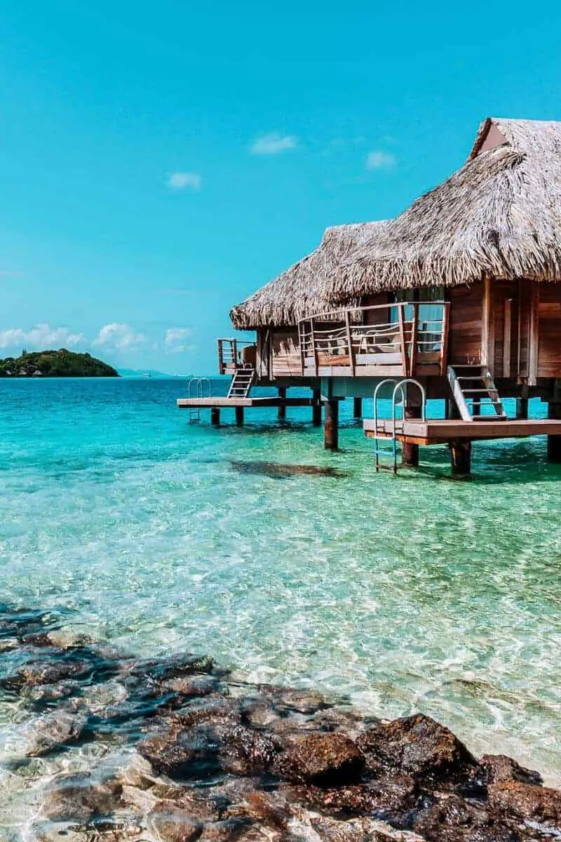 Several traditional overwater bungalows in a lagoon in French Polynesia