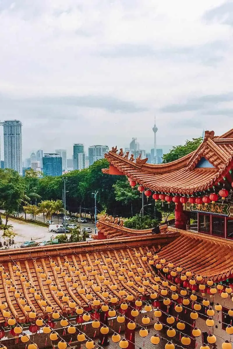 A traditional temple set in front of the modern skyline of Kuala Lumpur
