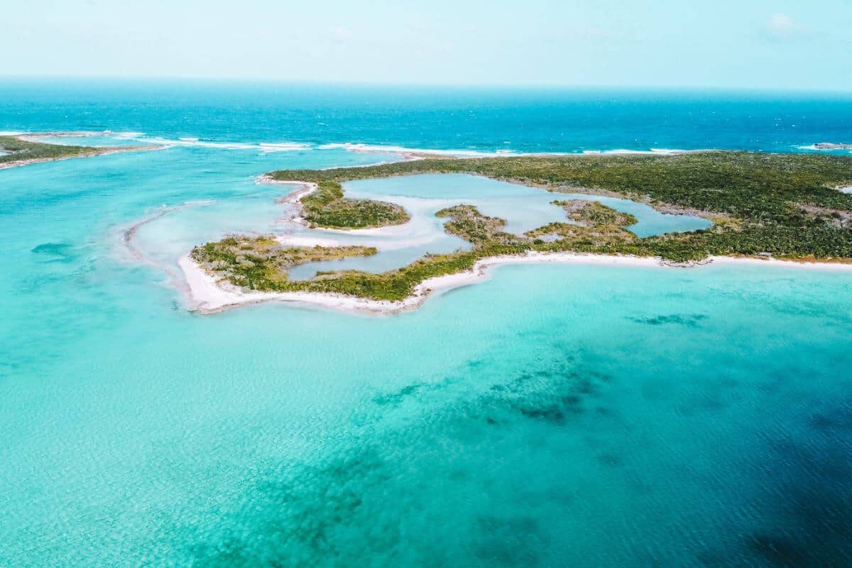 A flat, tropical island surrounded by turquoise sea in the Bahamas