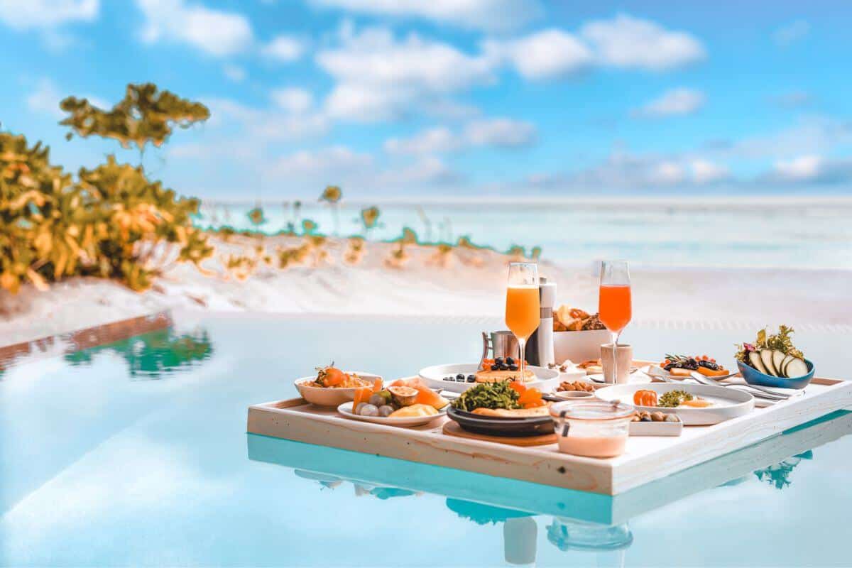 A floating breakfast tray in a pool by the beach
