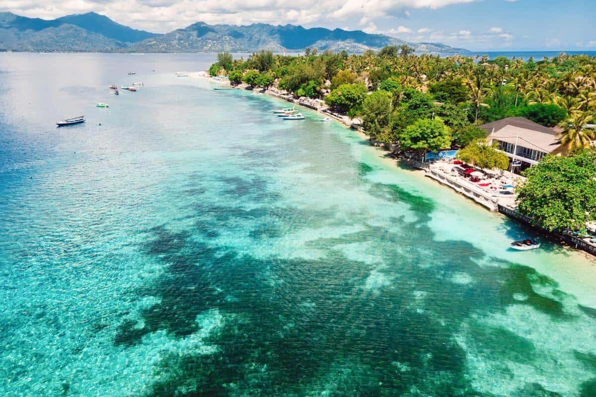 An aerial view of the turquoise coastline of one of the tropical Gili Islands
