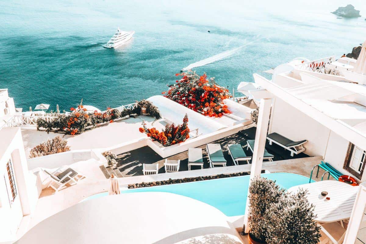 A view from a villa in Santorini looking over a pool towards the sea