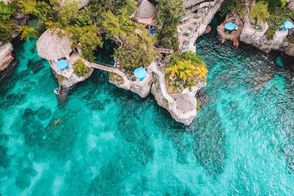 An aerial view of a Jamaican resort on a rugged, tropical coastline