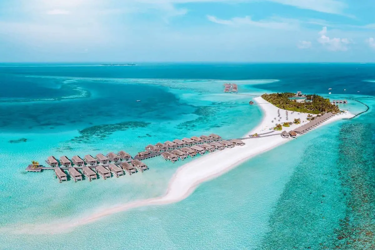 A resort with overwater villas on a tiny white-sand island in the Maldives