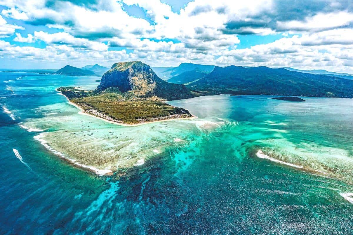 An aerial view of Mauritius with turquoise waters around the island