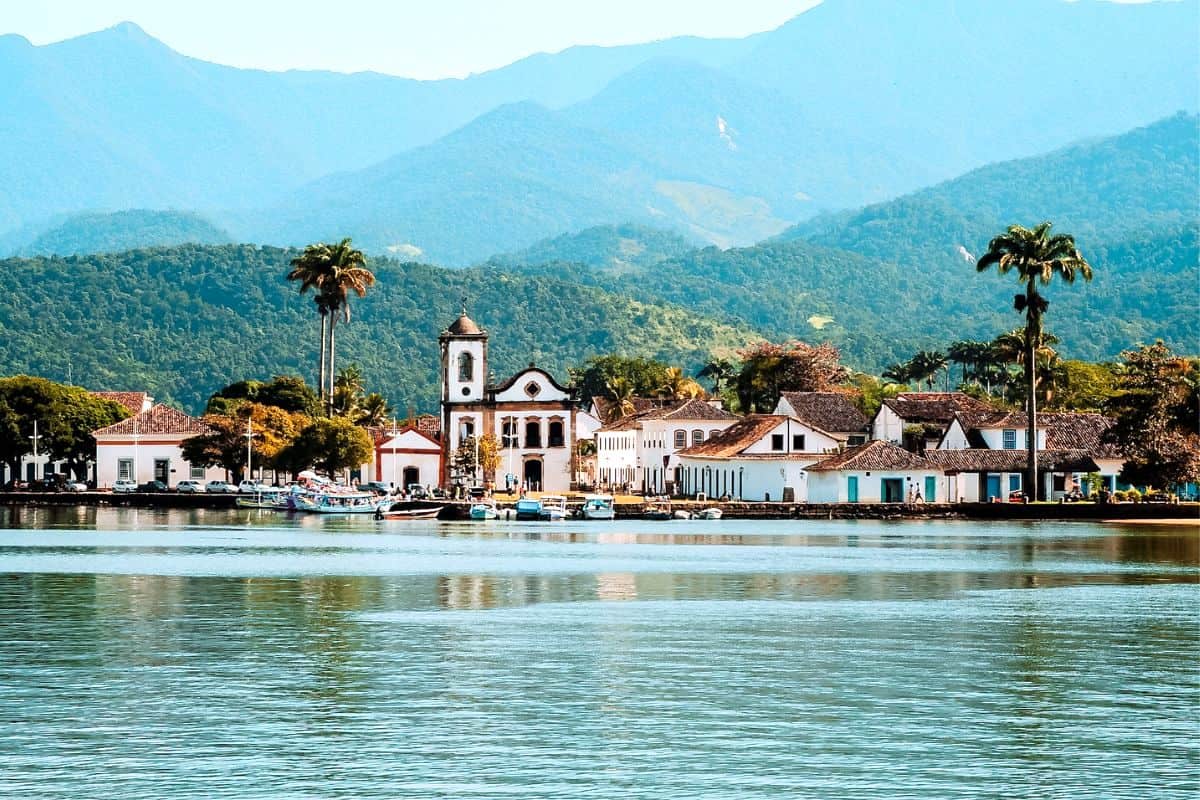 A view across water towards the colonial, coastal town of Paraty in Brazil