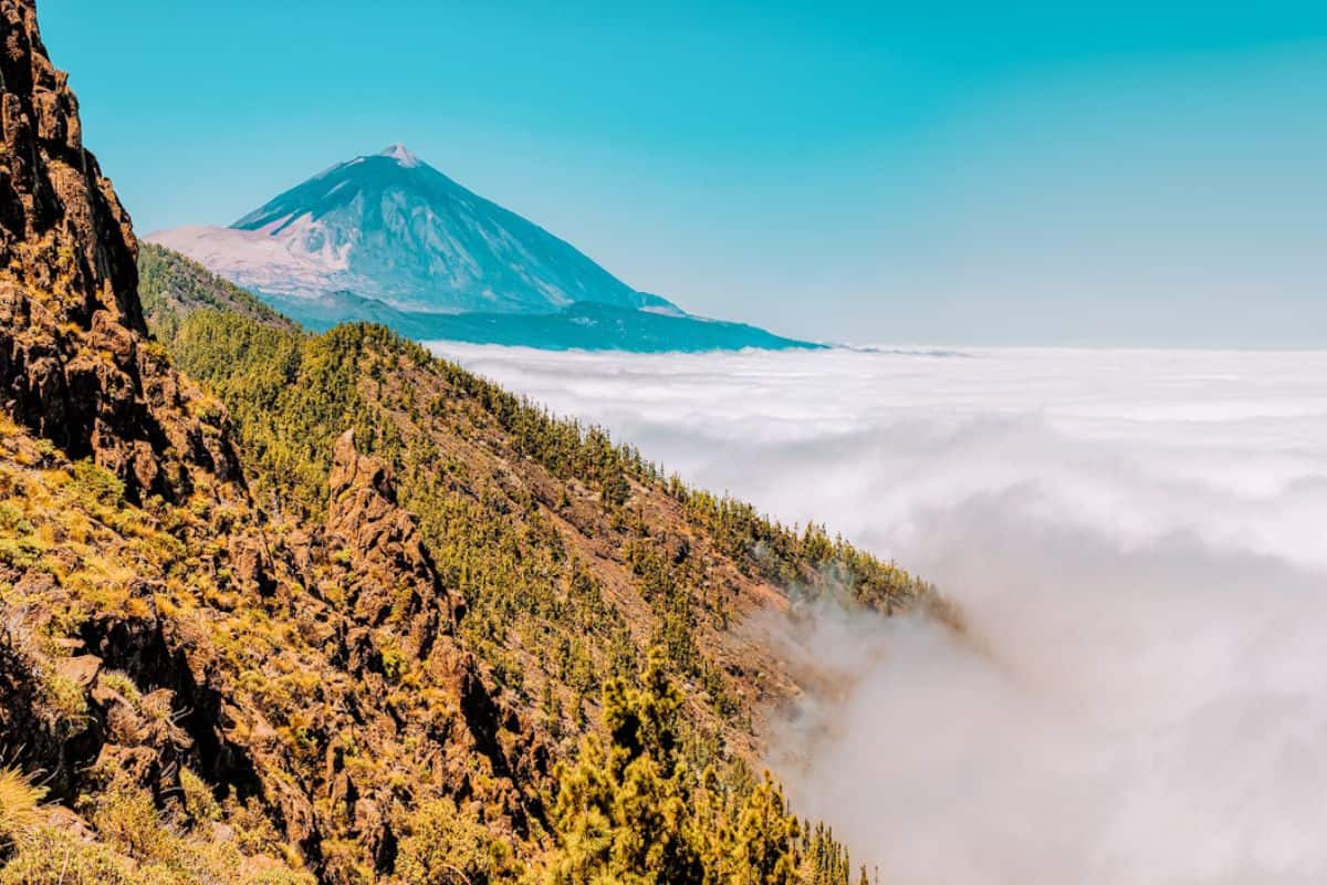 A view across a misty mountain landscape towards a volcano in Teide National Park in Tenerife