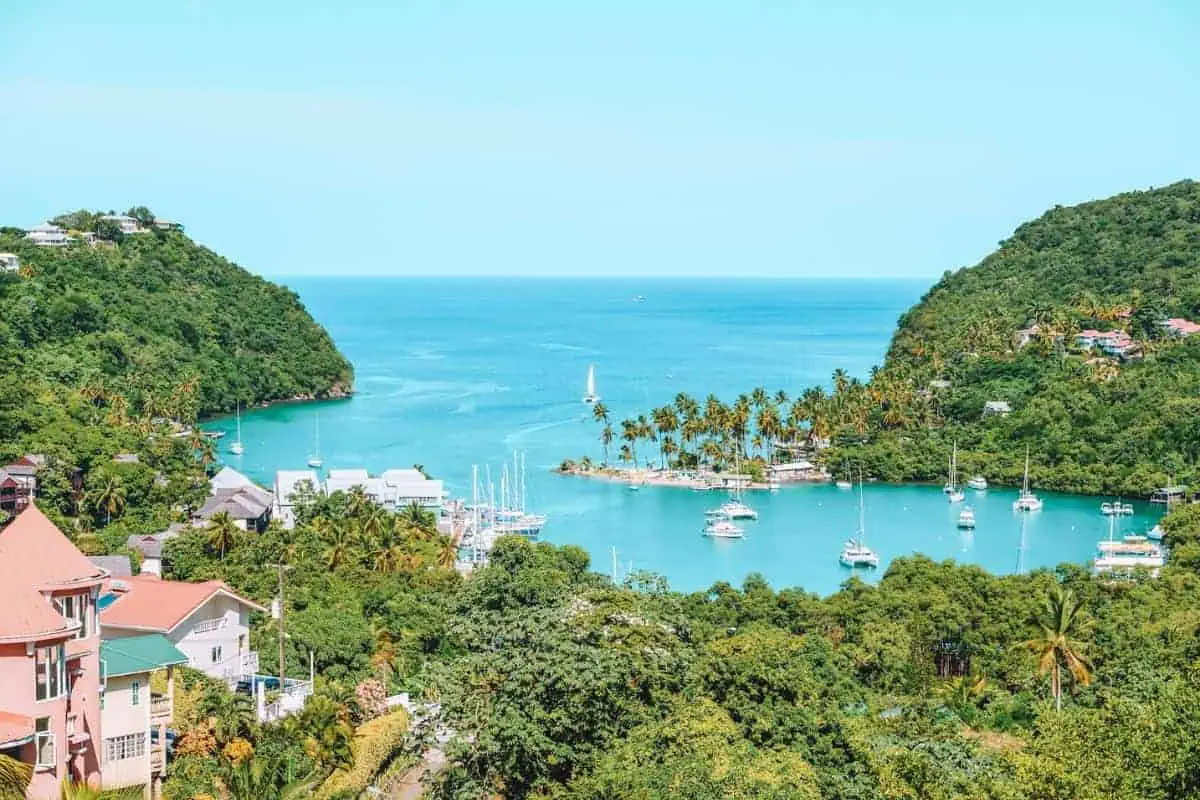 A tropical bay in St Lucia with sailing boats and lush jungle scenery