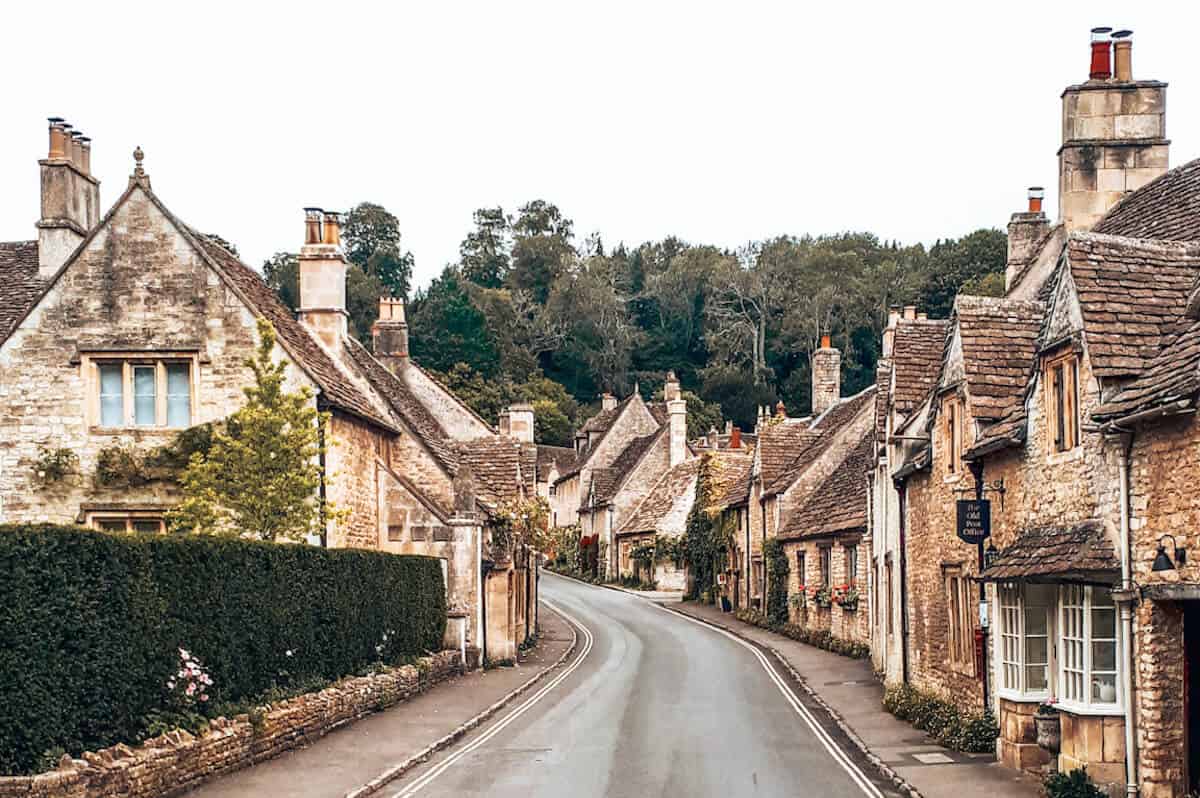 A road running through a quaint, historical village in the Cotswolds in England