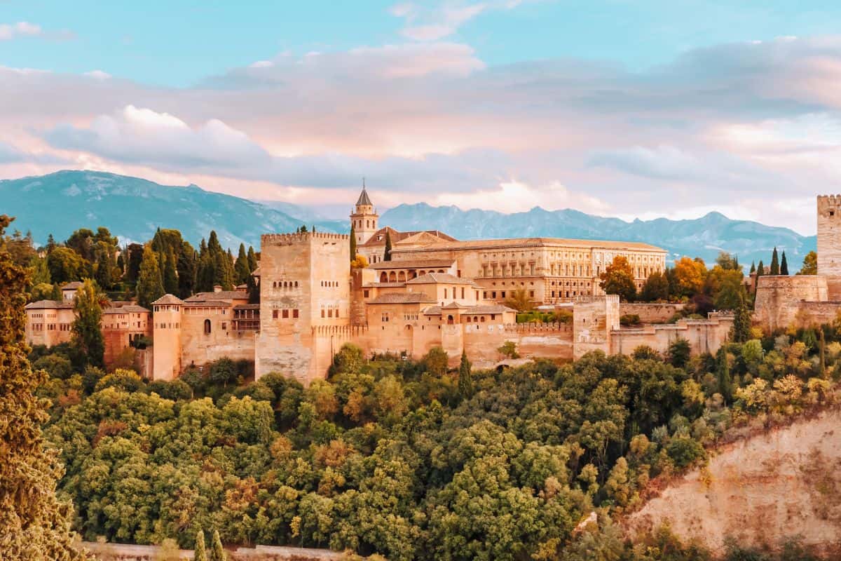A view towards grand, golden palace buildings in Alhambra in Granada, Spain