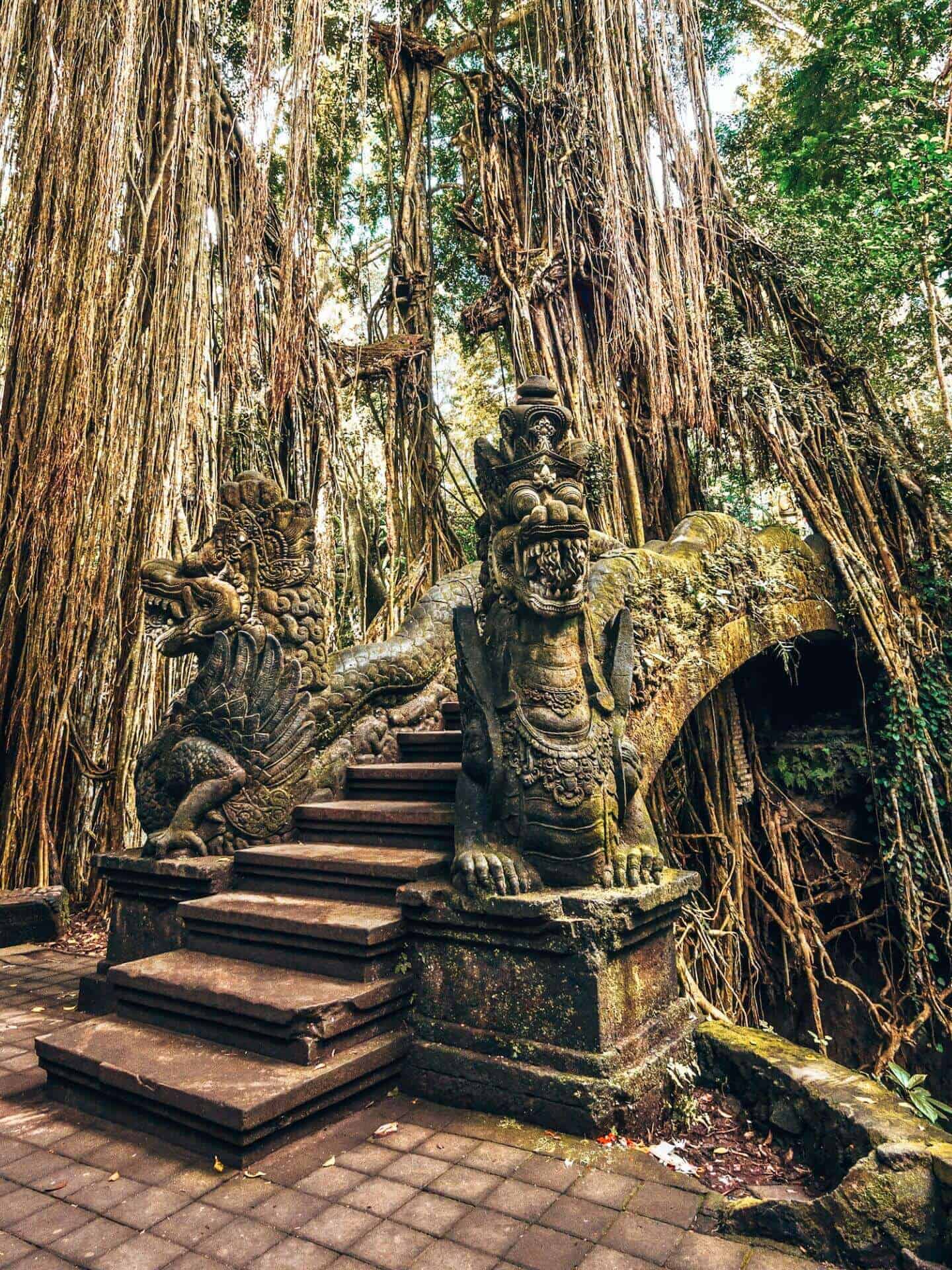 A bridge with Balinese statues in the Sacred Monkey Forest Sanctuary in Ubud, Bali