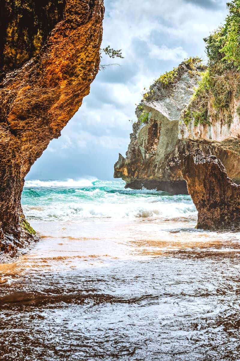 A hidden beach in Uluwatu, Bali in a secluded cove between rocks