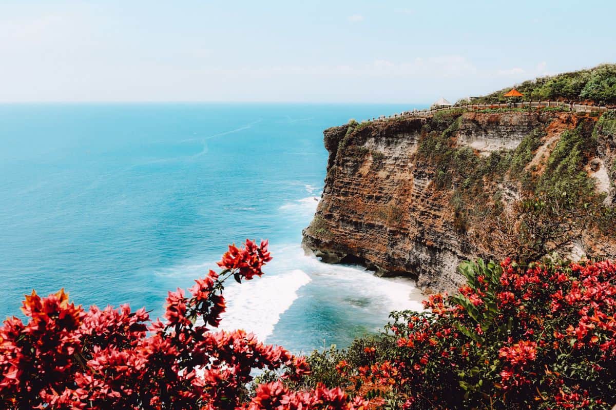 A view across a rugged coastal cliff at Uluwatu Temple in Bali