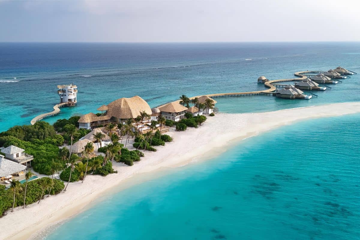 An aerial view of the exclusive Soneva Secret island resort in the Maldives with overwater accommodation