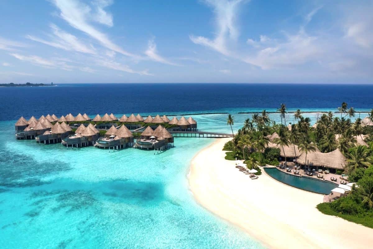 The Nautilus luxury island resort in the Maldives with a palm-fringed beach and overwater bungalows