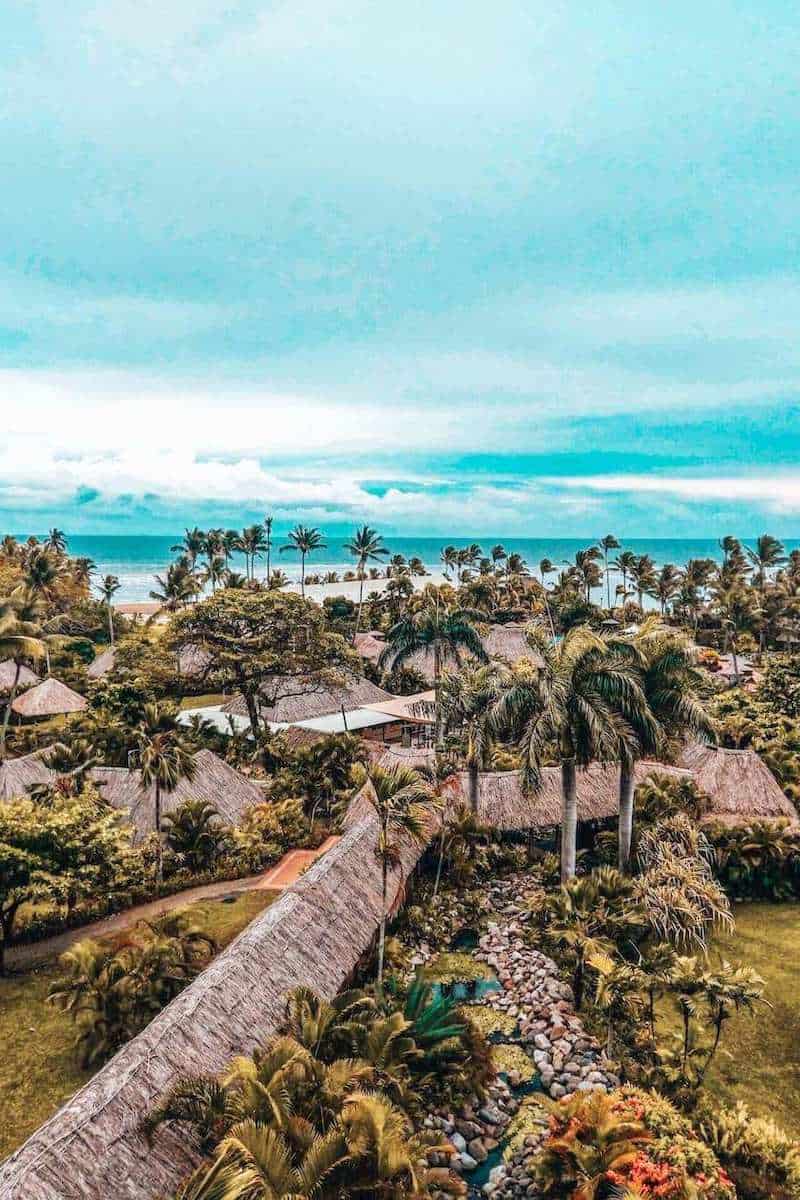 A beach resort in Fiji surrounded by palm trees