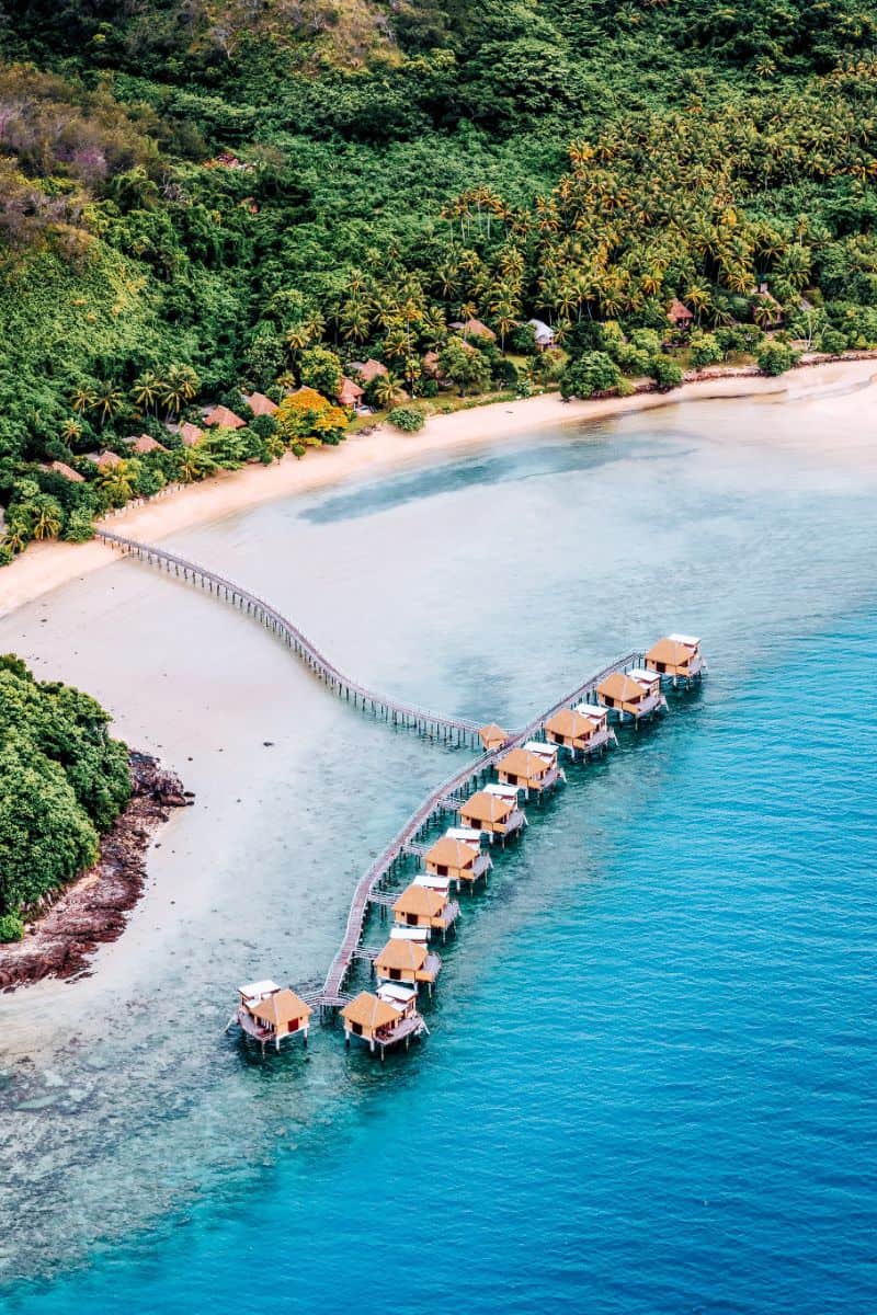 Aerial view of overwater bungalows at a resort in Fiji