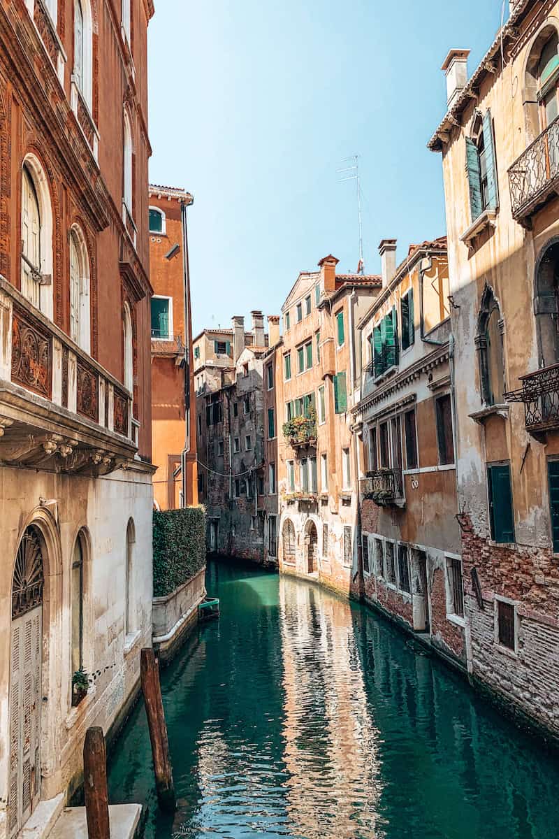 Old buildings bordering a narrow canal in Venice