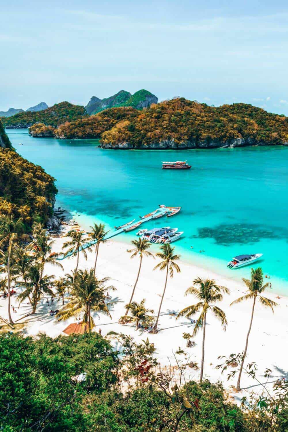 A view over a tropical, white-sand beach on Koh Samui island in Thailand