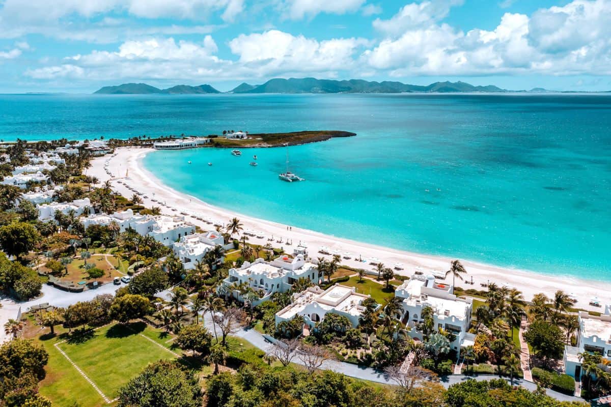 A sweeping bay in Anguilla with white sands and palm trees