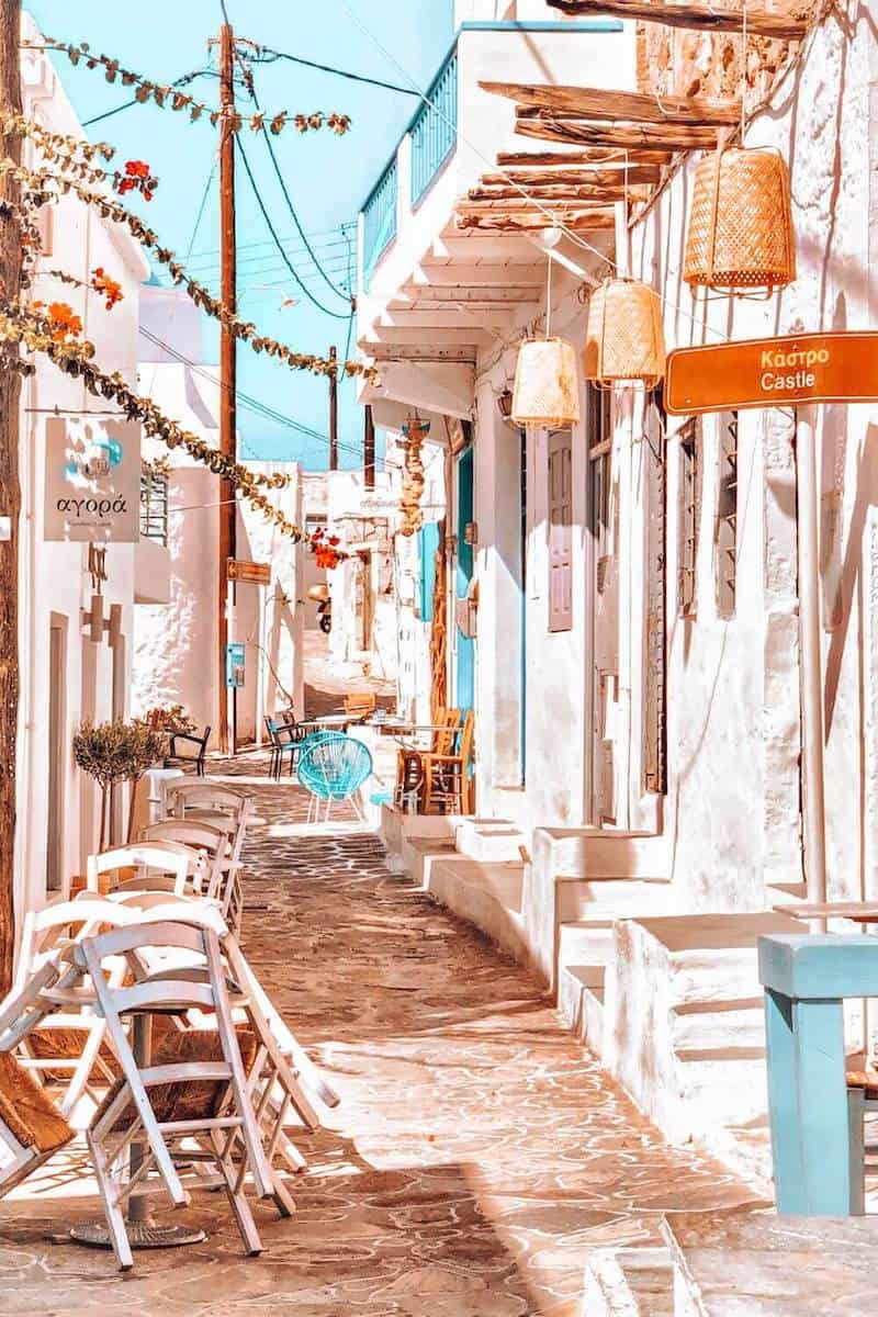 A narrow, white-washed street on Kimolos island in Greece