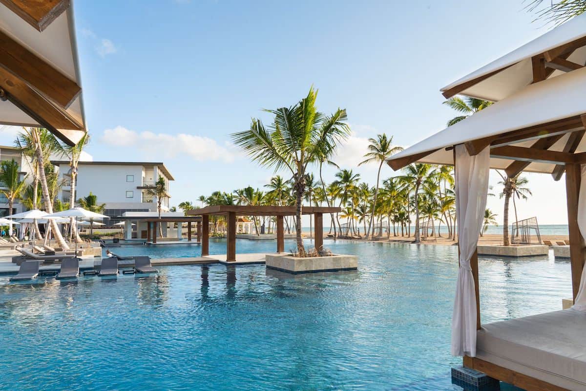 Day beds around an outdoor pool at a luxury Caribbean resort