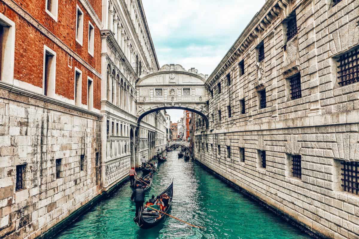 Several gondolas on a canal under the Bridge of Sighs in Venice
