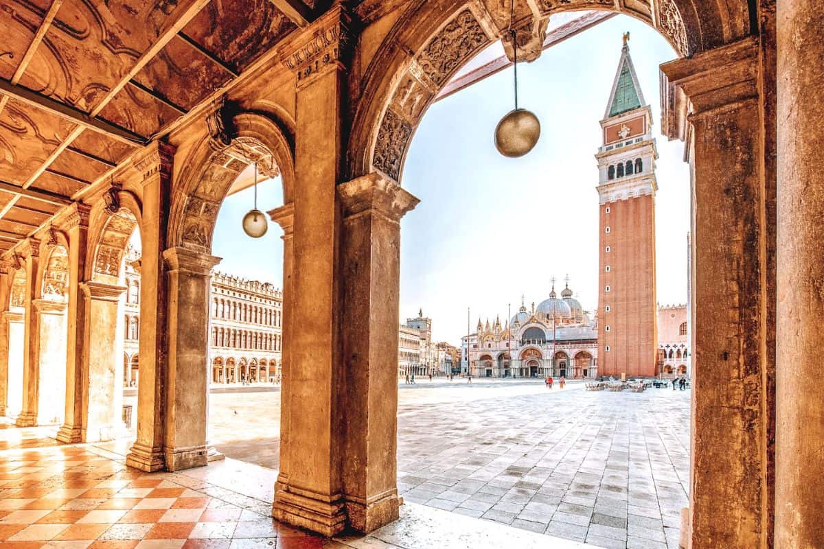 A view through an archway towards St Mark's Square and the campanile bell tower in Venice
