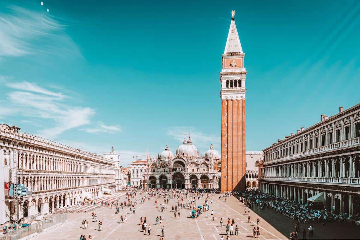A bell tower and crowds in St Mark's Square in Venice