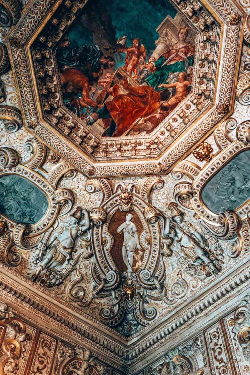 Ornate artwork and carvings on a grand ceiling in Venice