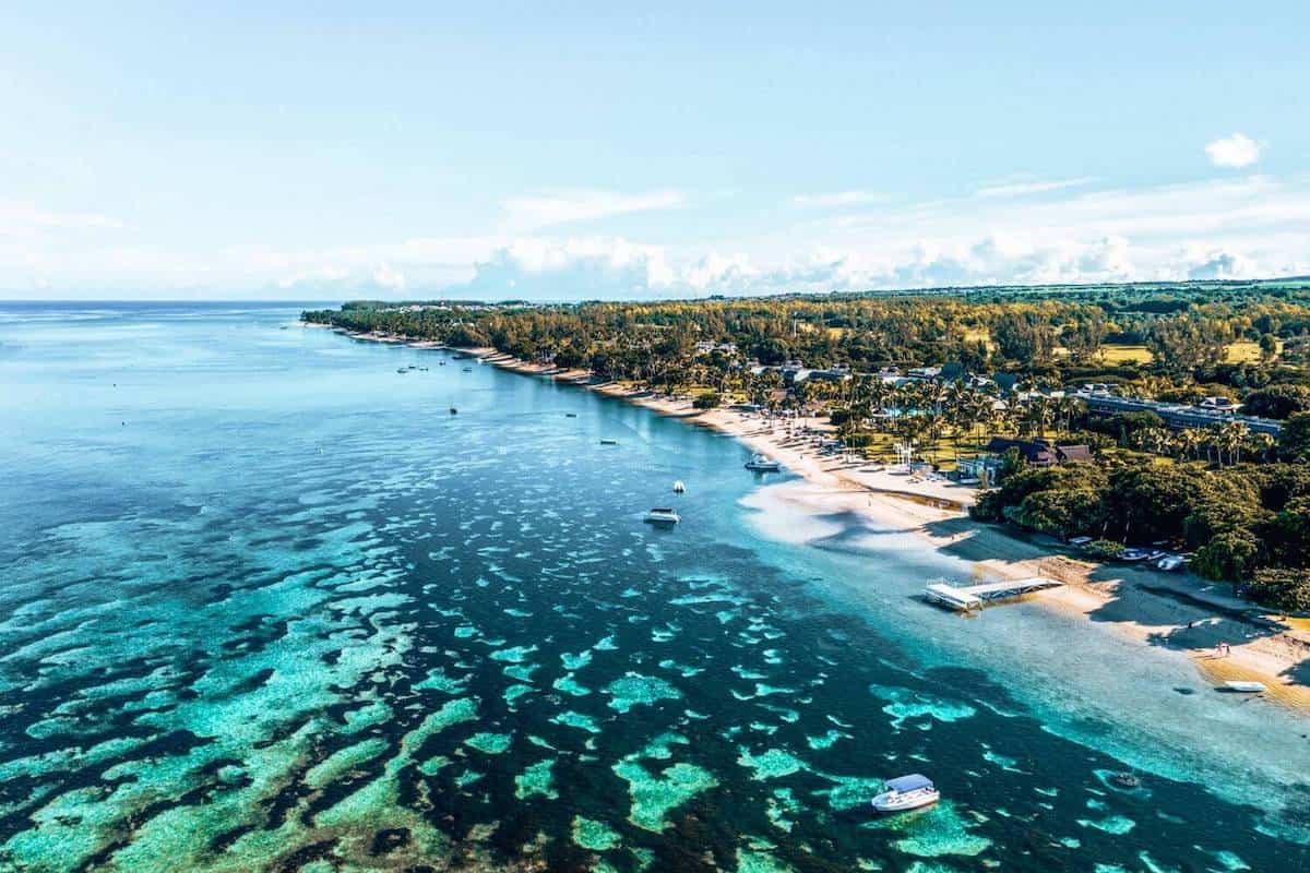 A view across coral-filled sea towards the island of Mauritius