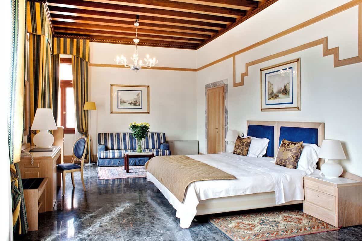 A spacious and romantic guest room at a four-star canal view hotel in Venice