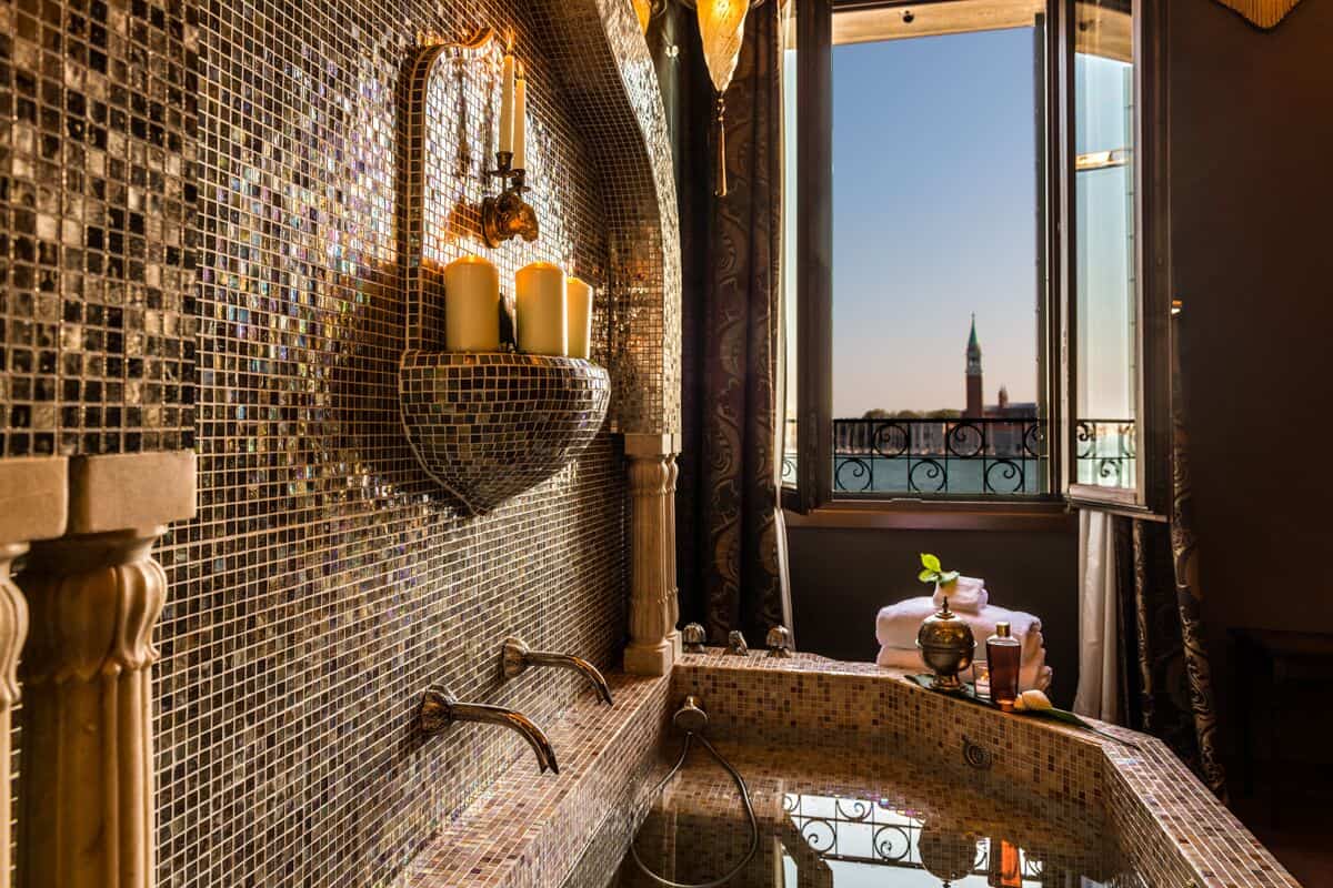 An ornate golden bathroom overlooking the Venetian Lagoon