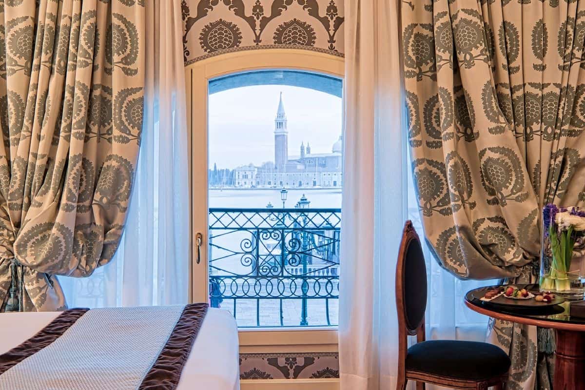 A view through a hotel window looking towards the Venetian Lagoon and the bell tower on San Giorgio Maggiore