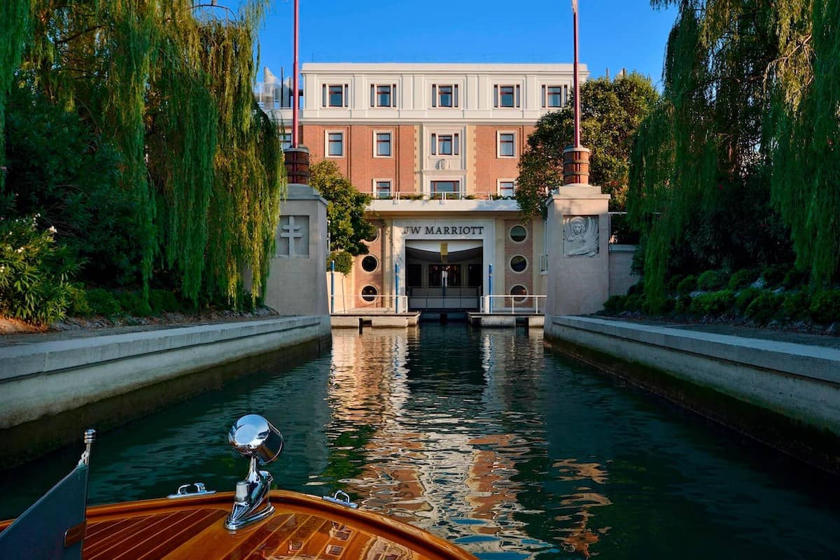 A boat on a canal approaching the entrance of JW Marriott Venice Resort & Spa