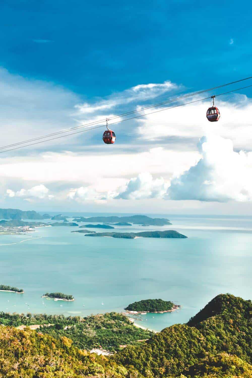 View from a mountain in Langkawi overlooking islands dotted in the sea and cable cars above