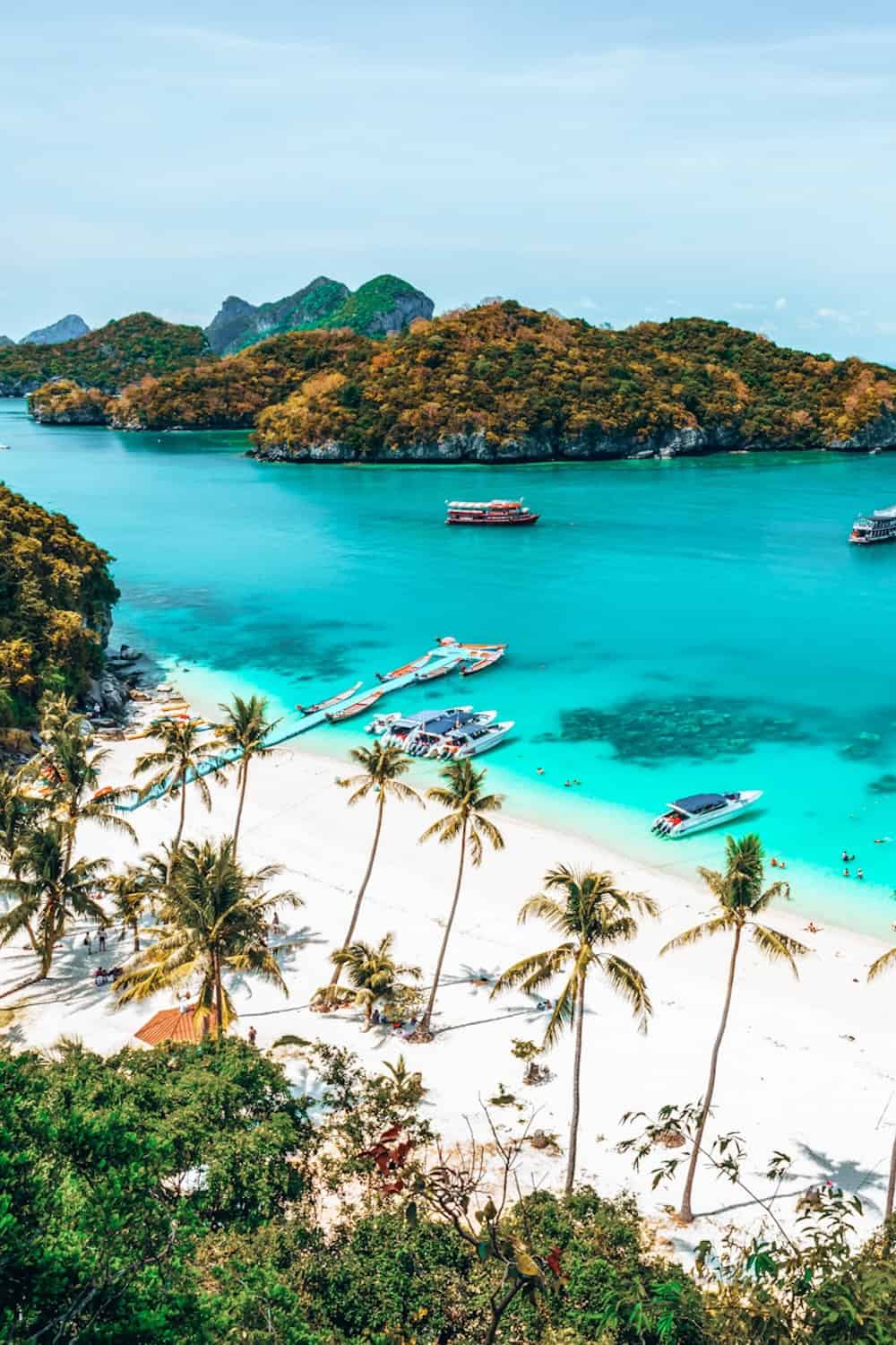 A view looking out towards turquoise sea, white sands and islands around Koh Samui, Thailand