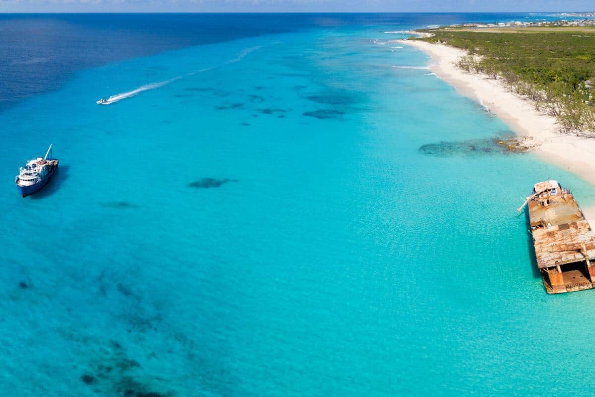 Clear water off the coast of Turks & Caicos with a shipwreck on the sands