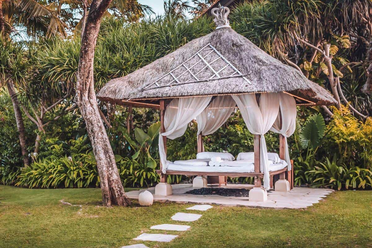 A traditional spa bed hut in a peaceful garden in Bali