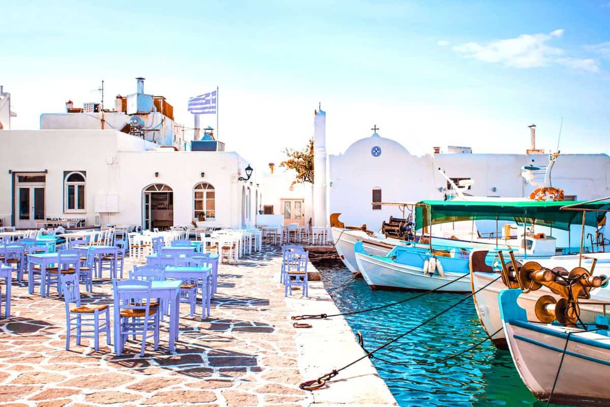 A quaint, white-washed harbour with boats in Paros, Greece