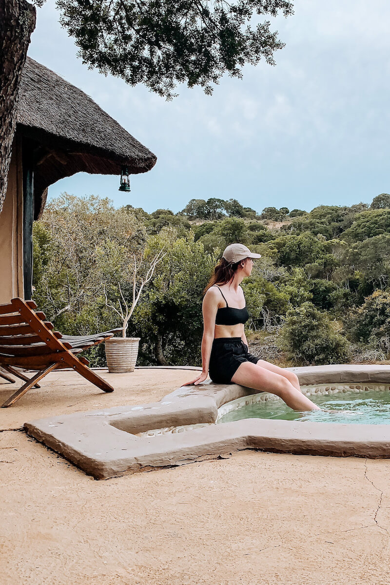 Hannah sitting by a private pool at a luxury safari lodge in South Africa